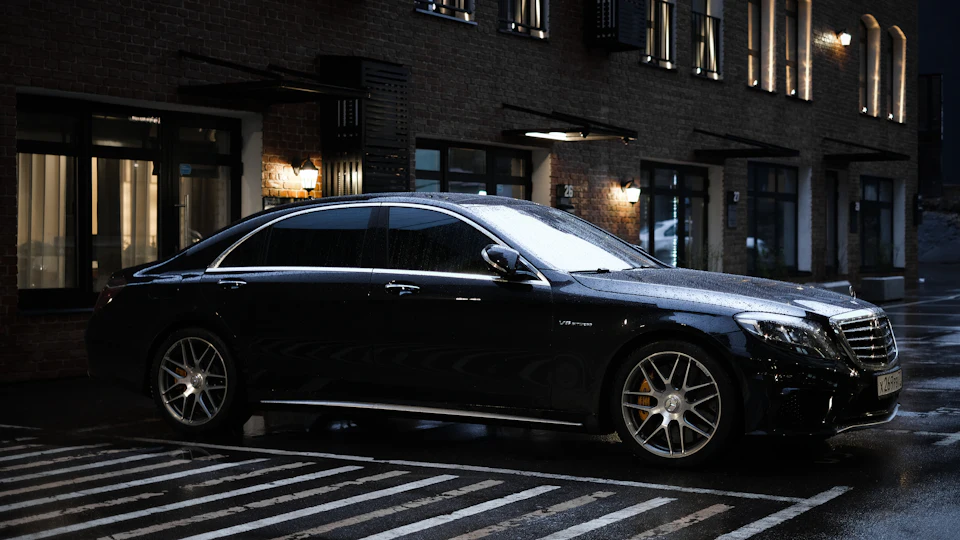 Black executive sedan parked on a city street Black executive sedan parked on a city street